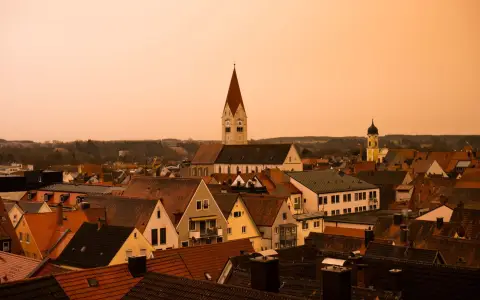 Symbolbild: Explore a picturesque sunset over Kaufbeuren's rooftops and iconic church towers.