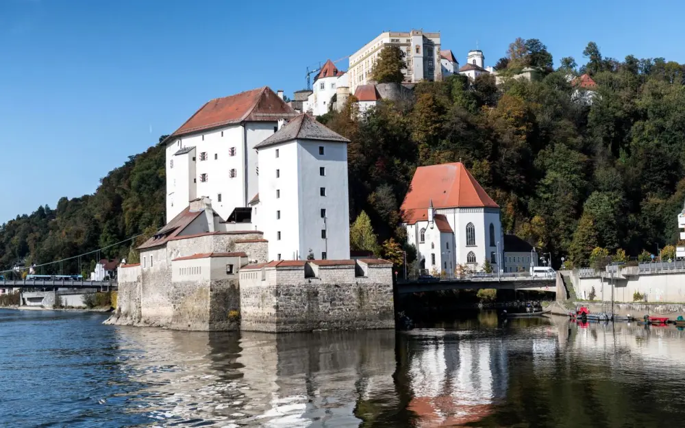 Symbolbild: Discover the historic beauty of Passau's castles reflected in tranquil river waters.