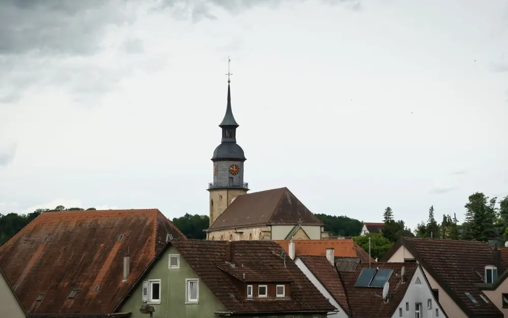 Symbolbild: A picturesque church tower rises above traditional German rooftops in Vaihingen an der Enz.
